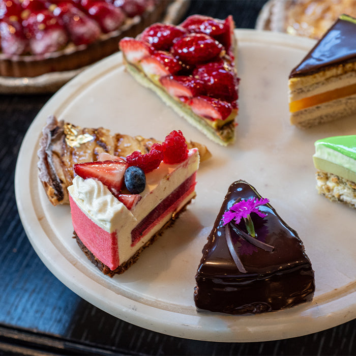 Assorted slices of cake on a plate from Belle Époque at Emporium Hotel